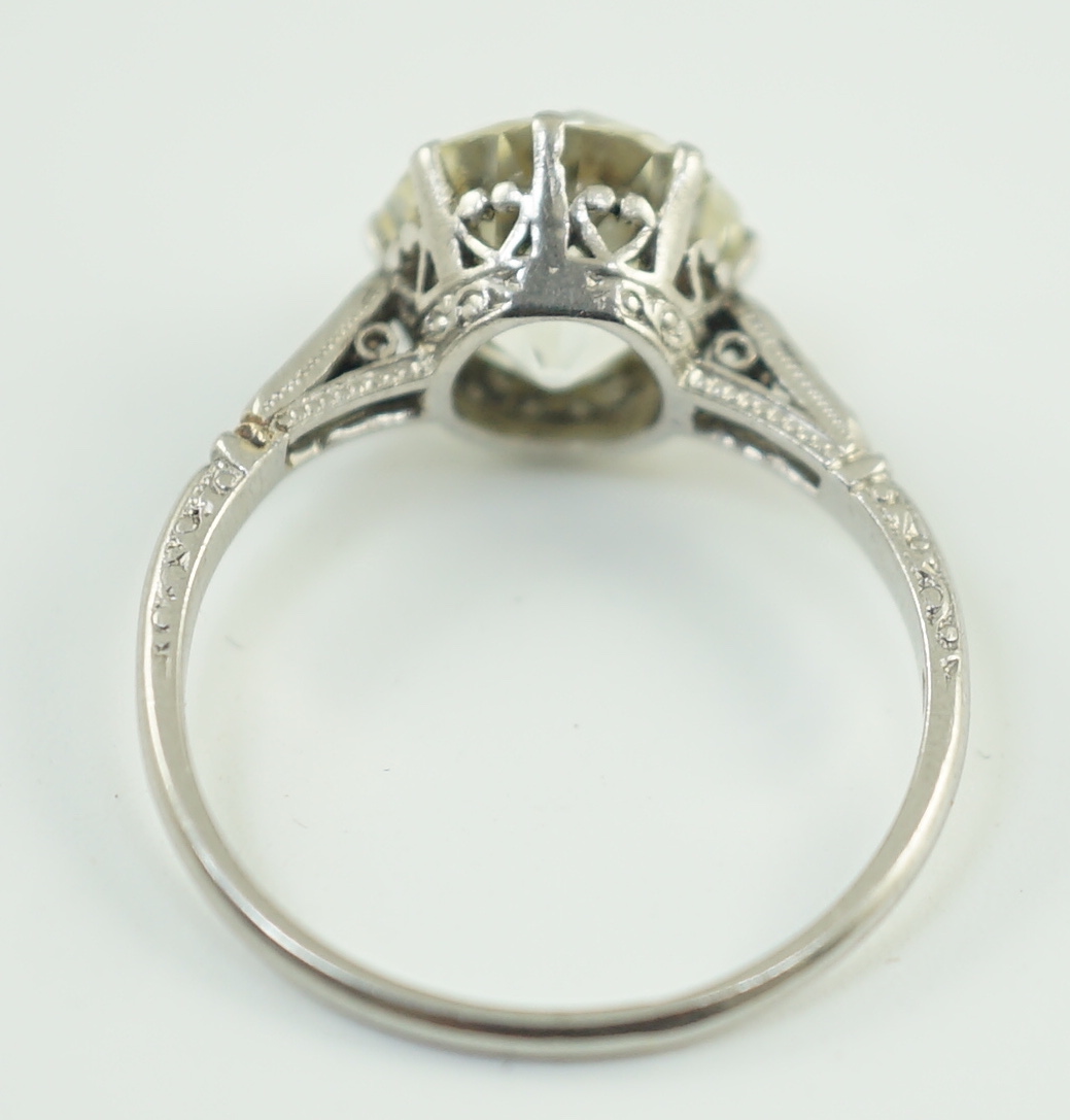 A mid 20th century platinum and single stone diamond ring, with six stone diamond chip set shoulders